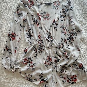 White floral romper with scrunchie tie details on shorts